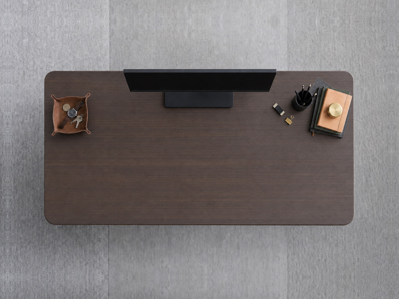 A JoyDesk desk topped in Dark Walnut Laminate at 1500mm, seen from above