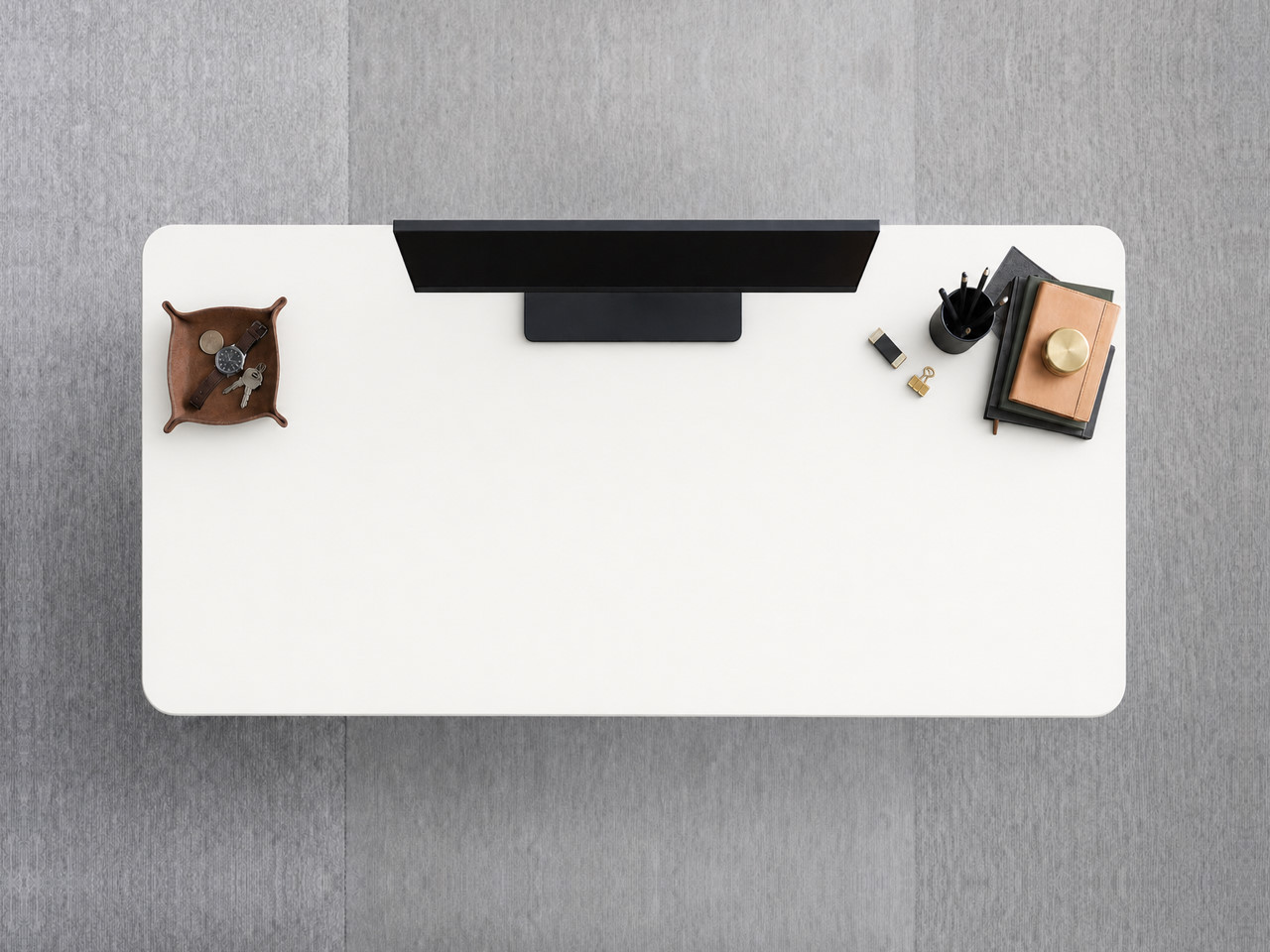 A JoyDesk desk topped in White Laminate at 1500mm, seen from above
